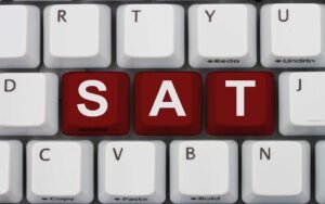 digital SAT pronoun antecedent agreement with sat written in purple on a gray keyboard