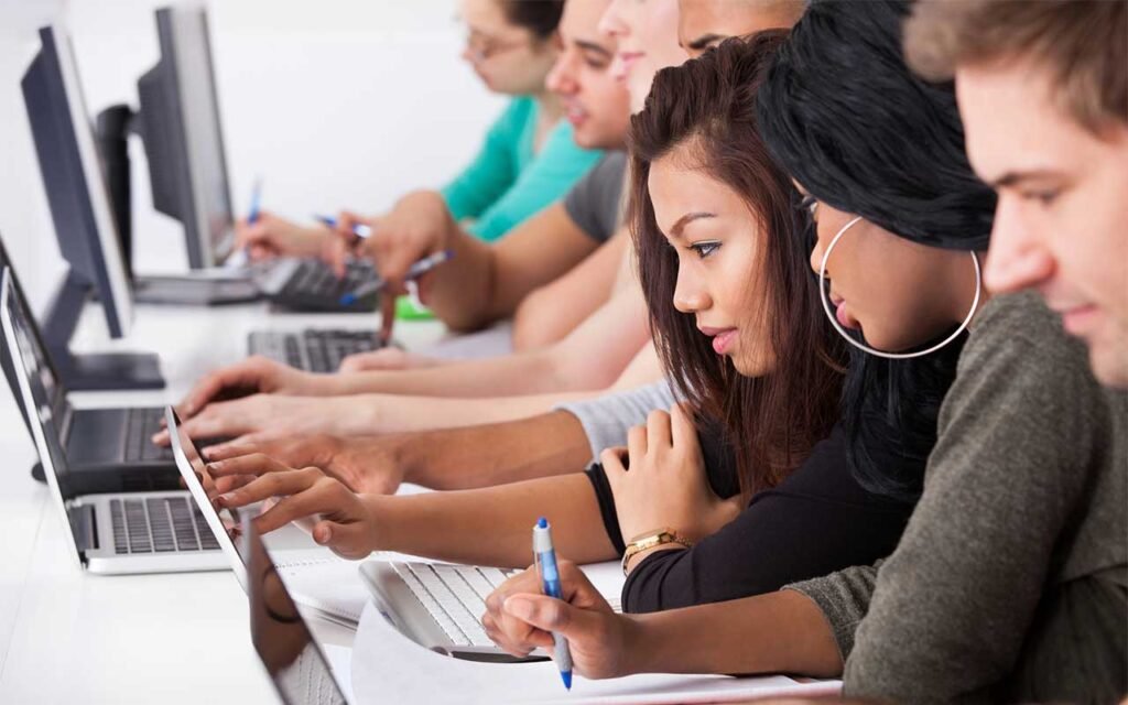 digital SAT grammar for beginners working on laptops